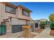 Two story townhome with a stone and iron fence and desert landscaping at 4339 Spencer St # 15, Las Vegas, NV 89119