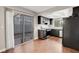 Well-lit kitchen with sleek black appliances, ample counter space, and sliding doors to the patio at 4339 Spencer St # 15, Las Vegas, NV 89119