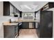 Functional kitchen featuring black appliances, a bright skylight, and plenty of cabinet space at 4339 Spencer St # 15, Las Vegas, NV 89119