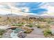 Expansive backyard with an elegant pond, rock features, and lush landscaping at 5741 N Park St, Las Vegas, NV 89149