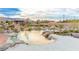 Inviting backyard featuring a sandy beach, pond, and lush landscaping creates a serene oasis at 5741 N Park St, Las Vegas, NV 89149