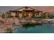 Backyard oasis showcases a serene pond and a covered patio with stylish outdoor seating at 5741 N Park St, Las Vegas, NV 89149