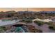 Expansive backyard features a zen-like pond, with a small bridge and desert landscaping at 5741 N Park St, Las Vegas, NV 89149