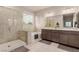Modern bathroom featuring a walk-in shower, soaking tub, and double sink vanity at 5741 N Park St, Las Vegas, NV 89149