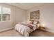 Bright bedroom showcasing wood floors, a large window, and a comfortable bed at 5741 N Park St, Las Vegas, NV 89149