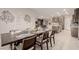 Modern dining room with seating for eight, open to the kitchen and living area at 5741 N Park St, Las Vegas, NV 89149