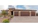 Inviting single-story home with desert landscaping, a three-car garage and a brick-paved driveway at 5741 N Park St, Las Vegas, NV 89149
