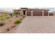 Attractive single-story home featuring a three-car garage and drought-tolerant desert landscaping at 5741 N Park St, Las Vegas, NV 89149