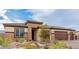 Attractive single-story home featuring a three-car garage and drought-tolerant desert landscaping at 5741 N Park St, Las Vegas, NV 89149
