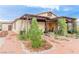 The exterior of the home has decorative rock landscaping, a covered patio and a private walkway at 5741 N Park St, Las Vegas, NV 89149