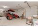 Spacious garage equipped with a tractor, an automated garage door, and ample storage space for vehicles and equipment at 5741 N Park St, Las Vegas, NV 89149