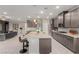 Spacious kitchen with large island, gray cabinets, and open floor plan to living area at 5741 N Park St, Las Vegas, NV 89149