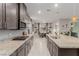 Spacious kitchen with gray cabinets, granite counters, stainless appliances, and open dining area at 5741 N Park St, Las Vegas, NV 89149