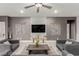 Modern living room featuring gray furniture and contemporary wall decorations around the TV at 5741 N Park St, Las Vegas, NV 89149