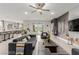 Open-concept living room with kitchen access, gray seating, and sliding door to patio at 5741 N Park St, Las Vegas, NV 89149