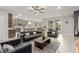 Bright living room with an open floor plan to kitchen, gray furniture and patio access at 5741 N Park St, Las Vegas, NV 89149