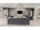 Contemporary living room featuring stylish gray sofas, recessed lighting, and ceramic floors at 5741 N Park St, Las Vegas, NV 89149