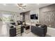 Contemporary living room with gray furniture, sleek TV, and decorative wall hangings at 5741 N Park St, Las Vegas, NV 89149