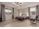 Bright bedroom features natural light from large windows and a ceiling fan at 5741 N Park St, Las Vegas, NV 89149