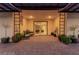 A covered patio with pavers and seating is decorated with potted plants and a modern light fixture at 5741 N Park St, Las Vegas, NV 89149