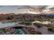 A scenic pond with rock accents is landscaped with wooden pathways leading to a cozy cabana at 5741 N Park St, Las Vegas, NV 89149