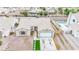 Front aerial view of the home showcasing desert landscaping, driveway, and sparkling pool in the neighborhood at 6124 Desert Haven Rd, Las Vegas, NV 89130