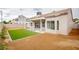 Beautiful backyard featuring a covered patio, artificial grass, and desert landscaping at 6124 Desert Haven Rd, Las Vegas, NV 89130