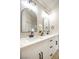 White bathroom vanity with double sinks, quartz countertops, arched mirrors, and matte black hardware at 6124 Desert Haven Rd, Las Vegas, NV 89130