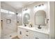 Bright bathroom featuring double sinks, modern fixtures, and a spacious marble tile shower at 6124 Desert Haven Rd, Las Vegas, NV 89130