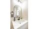 Bathroom vanity with a modern mirror, white marble countertop, and dark faucet at 6124 Desert Haven Rd, Las Vegas, NV 89130