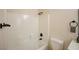 Bathroom featuring a white tile shower and tub combination at 6124 Desert Haven Rd, Las Vegas, NV 89130