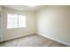 Bedroom featuring neutral carpet, baseboards, paint, and a large window at 6124 Desert Haven Rd, Las Vegas, NV 89130
