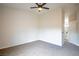 Bedroom with neutral carpet and paint, ceiling fan, and a window with backyard views at 6124 Desert Haven Rd, Las Vegas, NV 89130
