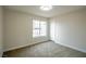 Bedroom with neutral carpet, baseboards, paint, and a large window at 6124 Desert Haven Rd, Las Vegas, NV 89130