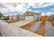 Charming home with low maintenance desert landscaping, two-car garage, and driveway at 6124 Desert Haven Rd, Las Vegas, NV 89130
