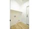 Laundry room with wood-look flooring, a shelf, and white paint at 6124 Desert Haven Rd, Las Vegas, NV 89130