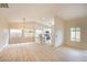 Open-concept living space with light wood floors and neutral walls with an eat-in kitchen at 6124 Desert Haven Rd, Las Vegas, NV 89130
