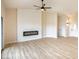 Bright living room featuring light wood floors, a modern fireplace, and an entry way at 6124 Desert Haven Rd, Las Vegas, NV 89130