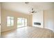Bright living room featuring light wood floors, a modern fireplace, and sliding glass doors at 6124 Desert Haven Rd, Las Vegas, NV 89130
