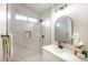 Bright bathroom with white marble tiles, shower head, built-in shower caddy, and a rectangular window at 6124 Desert Haven Rd, Las Vegas, NV 89130