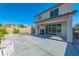Spacious backyard featuring a concrete patio, white picket fence, and covered outdoor seating area for relaxation at 6442 Kobe Knoll Ct, Las Vegas, NV 89141