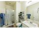 Bathroom featuring a glass-enclosed shower, white vanity, and a large mirror at 6442 Kobe Knoll Ct, Las Vegas, NV 89141