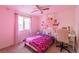 Bright bedroom with pink accents, a window with curtains, and a ceiling fan at 6442 Kobe Knoll Ct, Las Vegas, NV 89141