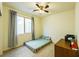 Bedroom with tile floor, window with curtains and a twin sized mattress on the floor at 6442 Kobe Knoll Ct, Las Vegas, NV 89141