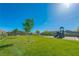 A vibrant community park with mature trees, lush green grass, and a playground for Gathering enjoyment at 6442 Kobe Knoll Ct, Las Vegas, NV 89141