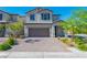 Charming two-story home with a brick driveway and landscaped front yard under a clear sky at 6442 Kobe Knoll Ct, Las Vegas, NV 89141