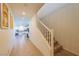 Bright hallway leads to an open kitchen with island; staircase on the right adds architectural interest at 6442 Kobe Knoll Ct, Las Vegas, NV 89141