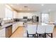 Kitchen with granite countertops, stainless steel appliances, island with seating, and dining area at 6442 Kobe Knoll Ct, Las Vegas, NV 89141