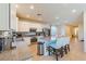 Bright, open-concept kitchen featuring a center island with seating, tile floors, and modern appliances at 6442 Kobe Knoll Ct, Las Vegas, NV 89141