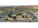 Elevated view featuring a pool, tennis courts, parking, and desert landscape, showcasing the community's amenities at 653 Paloma Cir, Mesquite, NV 89027